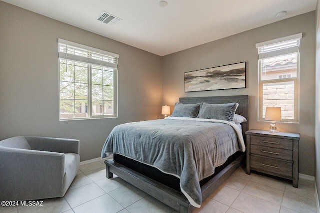 bedroom with baseboards, visible vents, and light tile patterned floors