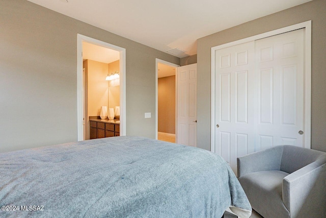 bedroom featuring a closet and ensuite bath