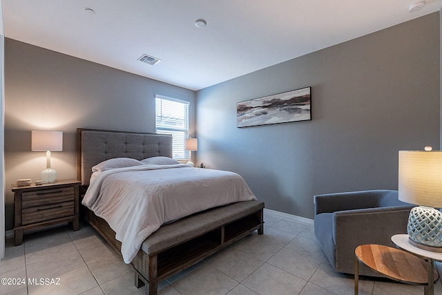 bedroom featuring light tile patterned flooring, visible vents, and baseboards