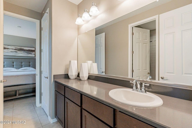 bathroom featuring connected bathroom, tile patterned flooring, and vanity