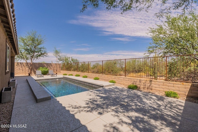 view of swimming pool featuring a patio, a fenced in pool, and a fenced backyard