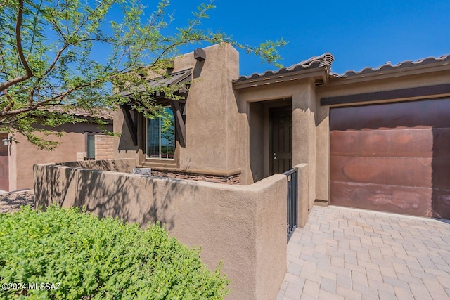 view of property exterior featuring fence and stucco siding