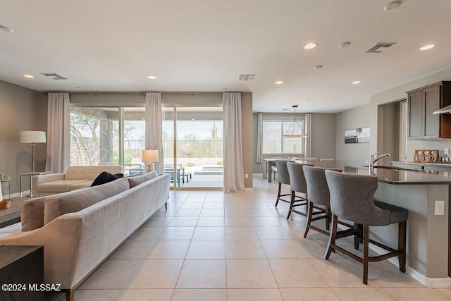 living area with recessed lighting, visible vents, baseboards, and light tile patterned flooring