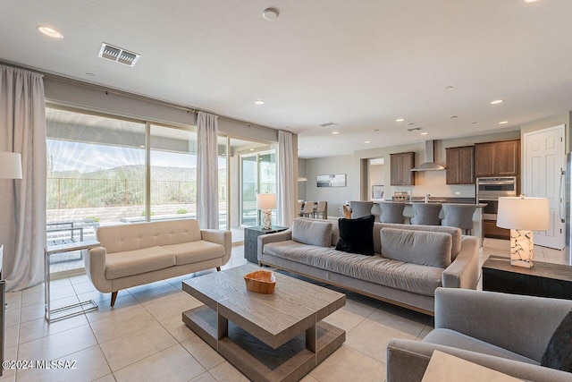 living area featuring recessed lighting, visible vents, a mountain view, and light tile patterned flooring