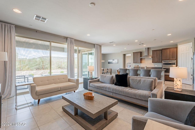 living room featuring a mountain view, visible vents, recessed lighting, and light tile patterned floors