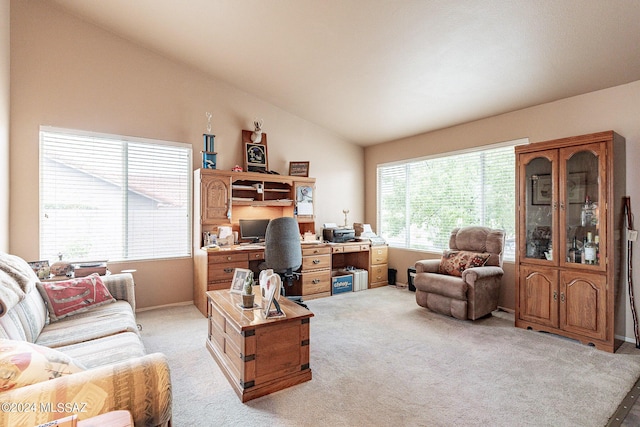 carpeted home office with vaulted ceiling