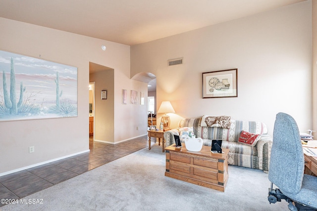 carpeted living room featuring vaulted ceiling