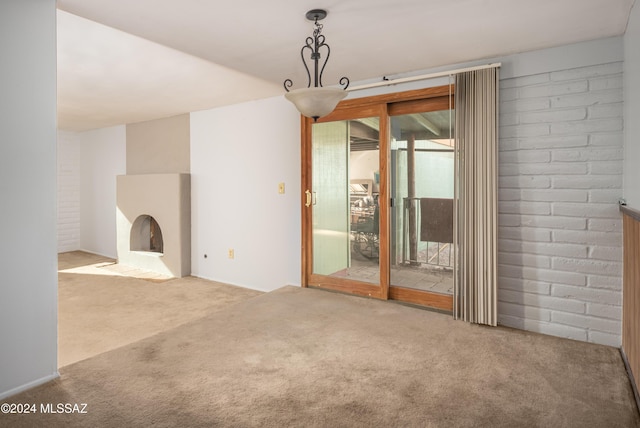 unfurnished living room featuring carpet flooring and a fireplace