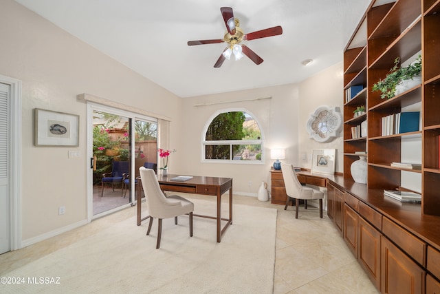 office area with light tile patterned flooring, vaulted ceiling, and ceiling fan