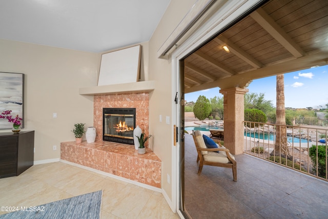 view of patio / terrace with a fenced in pool and a tile fireplace