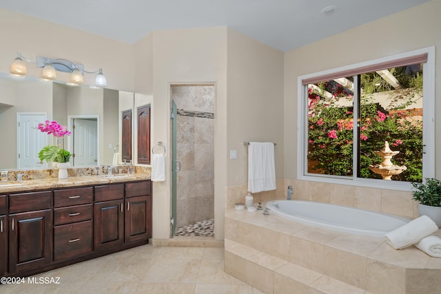 bathroom featuring tile patterned flooring, separate shower and tub, and vanity