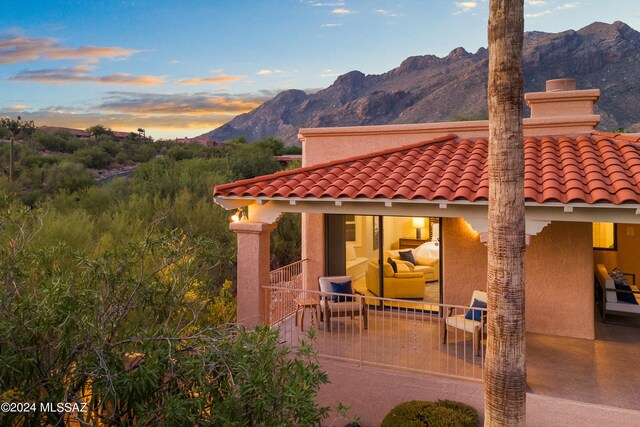 back house at dusk featuring a mountain view