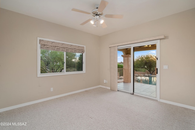 carpeted empty room featuring ceiling fan