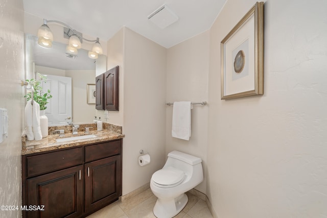 bathroom with tile patterned floors, vanity, and toilet