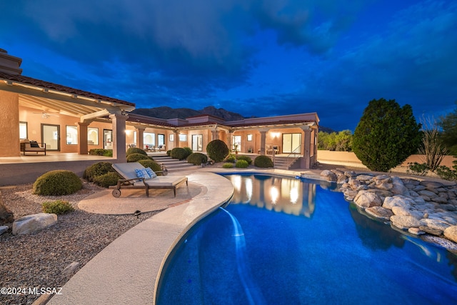 view of pool with ceiling fan and a patio