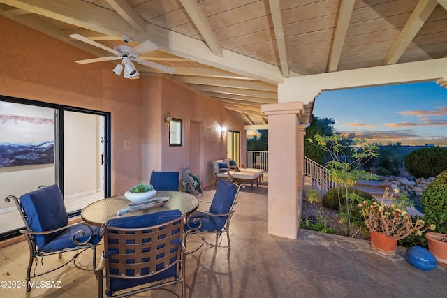 patio terrace at dusk featuring ceiling fan