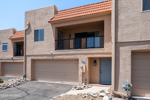 view of front of property with a garage and a balcony