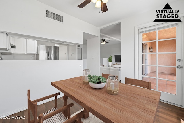 dining area featuring ceiling fan and dark hardwood / wood-style flooring