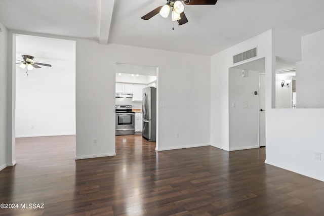 unfurnished living room featuring beamed ceiling, dark hardwood / wood-style floors, and ceiling fan