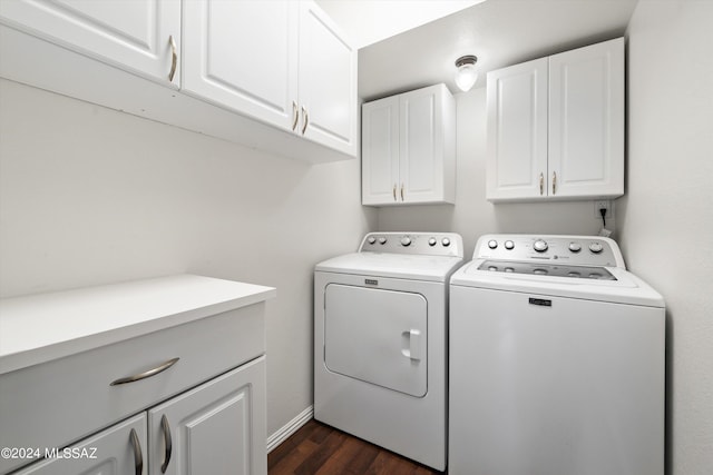 laundry area featuring dark wood-type flooring, cabinets, and washing machine and clothes dryer