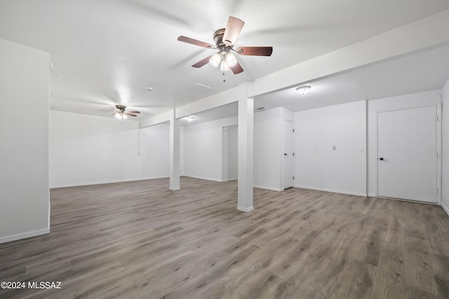 basement with hardwood / wood-style floors and ceiling fan