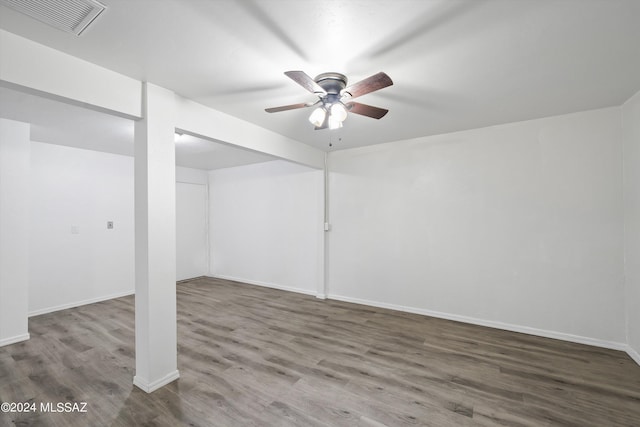 basement featuring hardwood / wood-style flooring and ceiling fan