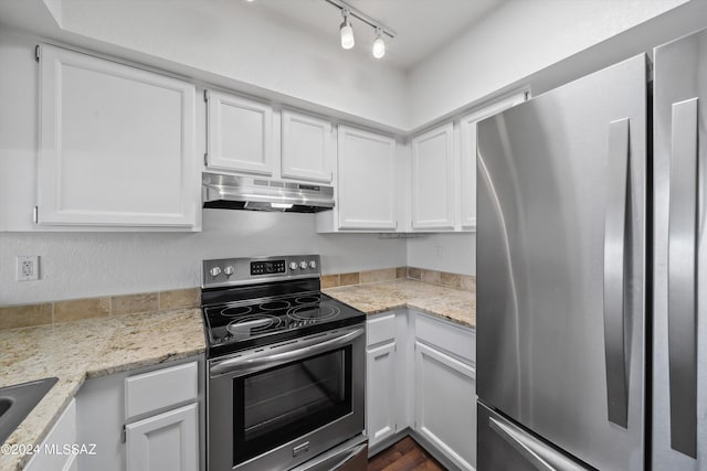 kitchen with light stone counters, sink, white cabinets, and appliances with stainless steel finishes