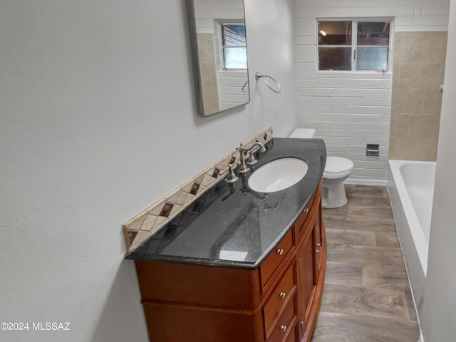 bathroom featuring vanity, toilet, and hardwood / wood-style floors