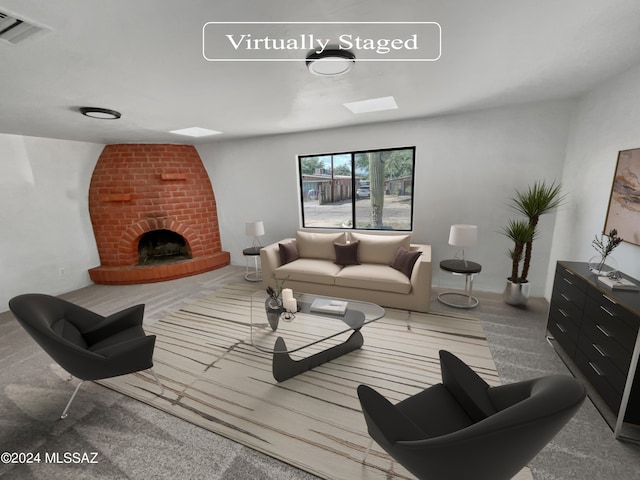 carpeted living room with a brick fireplace and a skylight