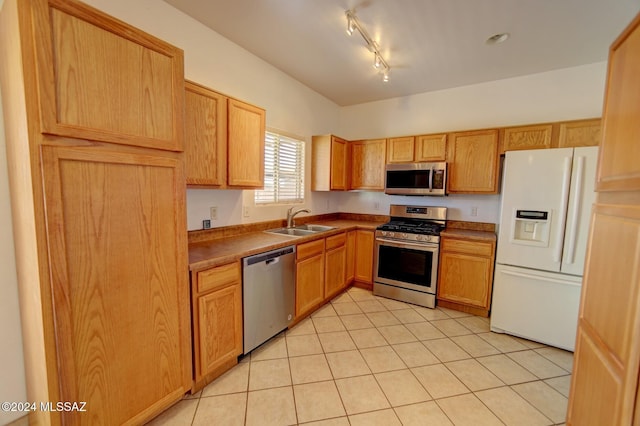 kitchen featuring sink, light tile patterned floors, and stainless steel appliances