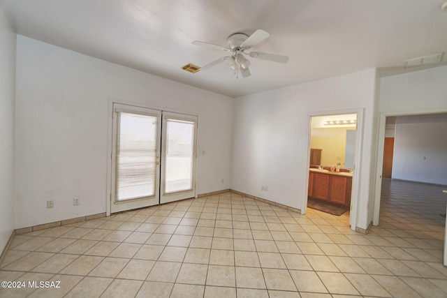 unfurnished room featuring light tile patterned floors and ceiling fan