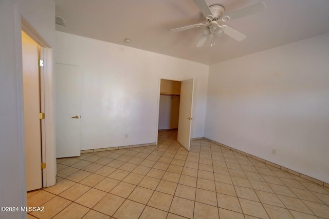 tiled spare room featuring ceiling fan