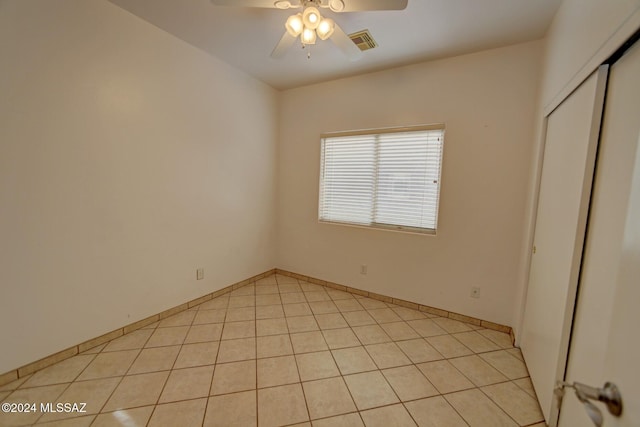 unfurnished bedroom featuring light tile patterned floors, a closet, and ceiling fan