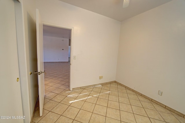 unfurnished room with ceiling fan and light tile patterned floors