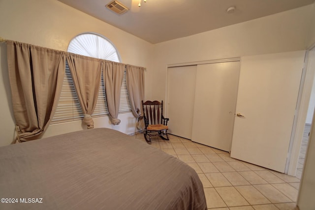 unfurnished bedroom with a closet and light tile patterned flooring