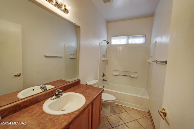 full bathroom with tile patterned floors, vanity, tiled shower / bath combo, and toilet