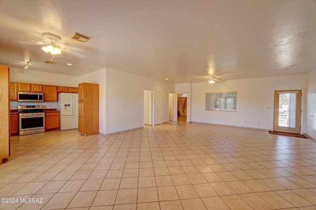 unfurnished living room featuring ceiling fan and light tile patterned flooring