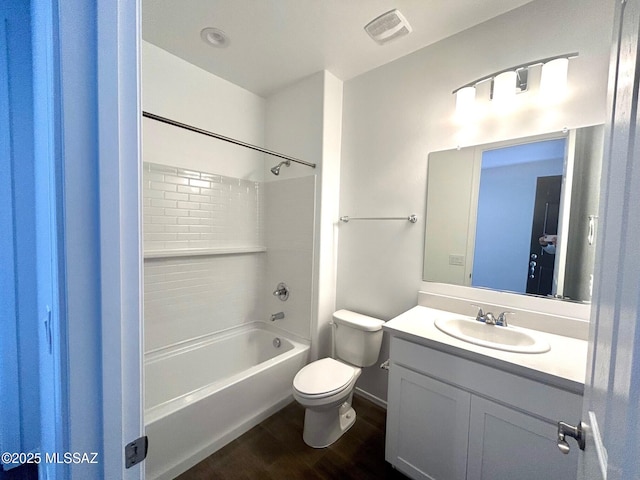 full bathroom with vanity, hardwood / wood-style flooring,  shower combination, and toilet