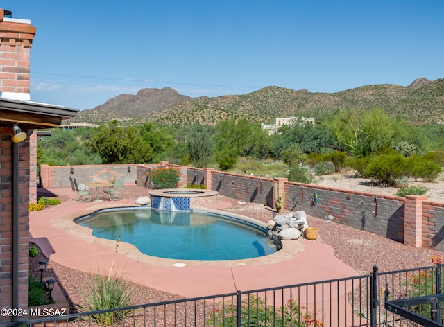 view of pool featuring a mountain view, an in ground hot tub, and a patio