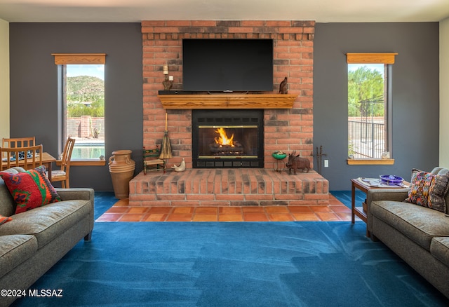 carpeted living room featuring a wealth of natural light and a brick fireplace