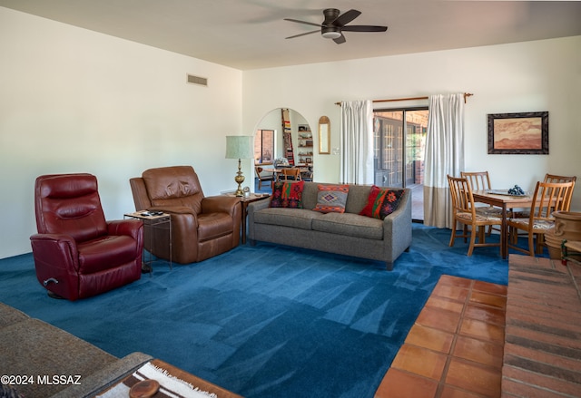 living room with dark carpet and ceiling fan