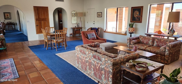 tiled living area with visible vents and arched walkways