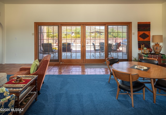 dining space featuring french doors and light tile patterned floors