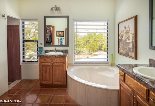 full bathroom with a sink, a healthy amount of sunlight, and tile patterned floors