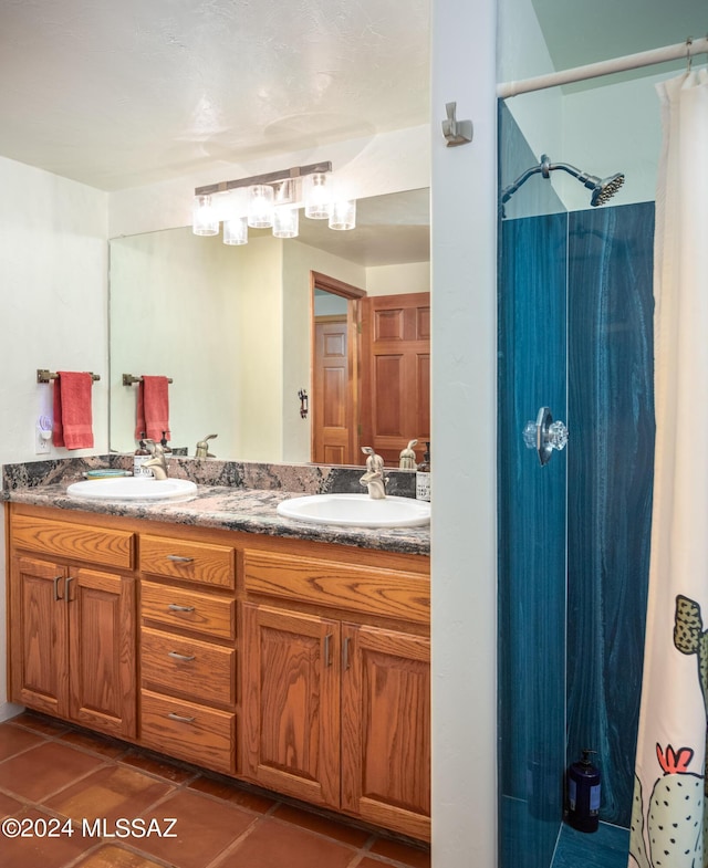 bathroom with tile patterned flooring, double vanity, a shower with curtain, and a sink