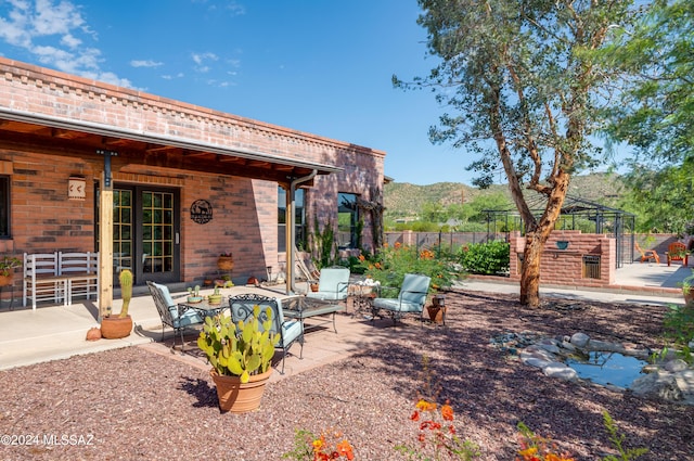 view of yard with a gazebo, a mountain view, a patio, and fence