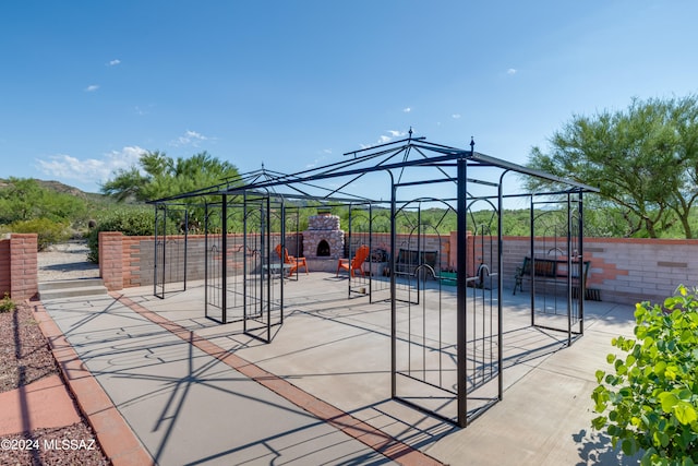 view of playground featuring a gazebo and an outdoor fireplace