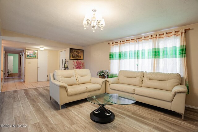 living room featuring light hardwood / wood-style floors and an inviting chandelier