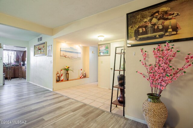 hallway featuring light tile patterned floors