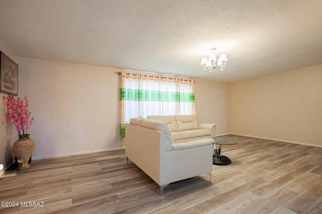 living room featuring hardwood / wood-style floors and an inviting chandelier